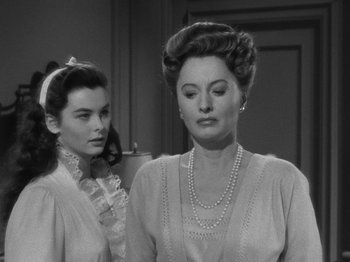 Movie still from “Titanic” (1953), directed by Jean Negulesco – Two women are standing next to each other in a room; Close Up shot, Over the shoulder angle