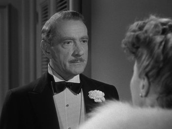 Movie still from “Titanic” (1953), directed by Jean Negulesco – An older man in a tuxedo looking at a woman in a dress; Close Up shot, Over the shoulder angle
