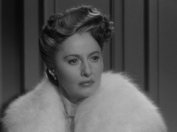 Movie still from “Titanic” (1953), directed by Jean Negulesco – An old photo of a woman in a fur coat; Close Up shot, Over the shoulder angle