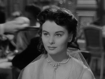 Movie still from “Titanic” (1953), directed by Jean Negulesco – A black - and - white photo of a woman in a white dress; Close Up shot, Over the shoulder angle