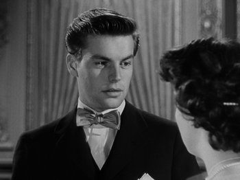 Movie still from “Titanic” (1953), directed by Jean Negulesco – A man in a suit and bow tie looking at a woman in a suit; Close Up shot, Over the shoulder angle