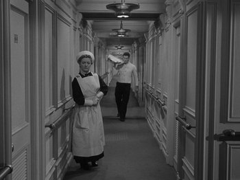 Movie still from “Titanic” (1953), directed by Jean Negulesco – A man and a woman are walking down a long hallway; Wide shot, High angle