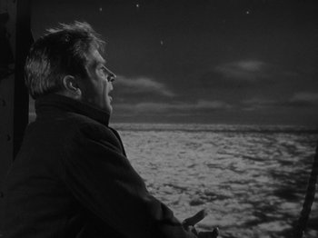 Movie still from “Titanic” (1953), directed by Jean Negulesco – A black and white photo of a man looking out over the ocean; Medium shot, High angle