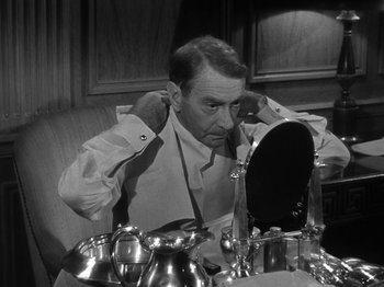 Movie still from “Titanic” (1953), directed by Jean Negulesco – A black and white photo of a man putting on a shirt; Close Up shot, Over the shoulder angle