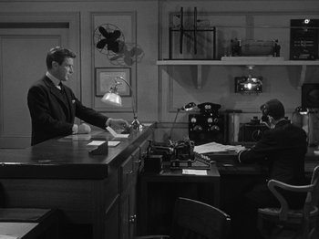 Movie still from “Titanic” (1953), directed by Jean Negulesco – Two men are sitting at a desk in a room; Wide shot, High angle