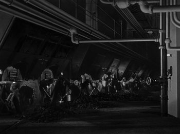 Movie still from “Titanic” (1953), directed by Jean Negulesco – A black and white photo of people working in an industrial setting; Extreme Wide shot, High angle
