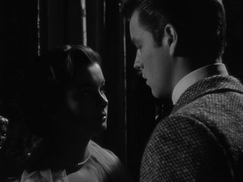 Movie still from “Titanic” (1953), directed by Jean Negulesco – A man and a woman standing next to each other; Close Up shot, Over the shoulder angle