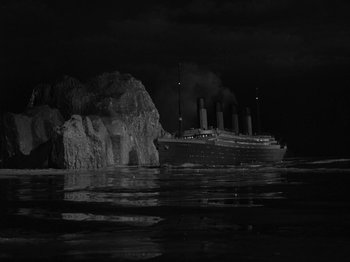 Movie still from “Titanic” (1953), directed by Jean Negulesco – A boat floating on top of a body of water near rocks; Extreme Wide shot, Low angle