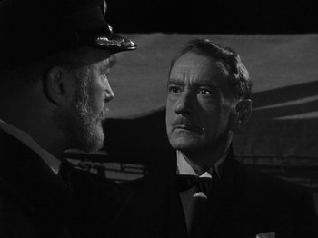 Movie still from “Titanic” (1953), directed by Jean Negulesco – A man in a suit standing next to another man in a tie; Close Up shot, Over the shoulder angle