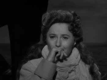 Movie still from “Titanic” (1953), directed by Jean Negulesco – A black - and - white photo of a woman with her hand under her chin; Close Up shot, Over the shoulder angle