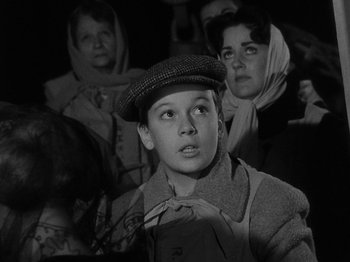 Movie still from “Titanic” (1953), directed by Jean Negulesco – A young boy wearing a hat and a scarf; Close Up shot, High angle