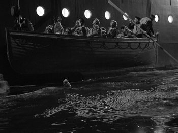 Movie still from “Titanic” (1953), directed by Jean Negulesco – A group of people in a boat in a body of water; Extreme Wide shot, High angle