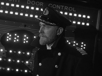 Movie still from “Titanic” (1953), directed by Jean Negulesco – Black and white photograph of a man in a naval uniform; Medium shot, Low angle