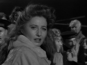 Movie still from “Titanic” (1953), directed by Jean Negulesco – A black - and - white photo of a woman in a crowd; Close Up shot, Over the shoulder angle