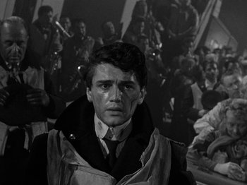 Movie still from “Titanic” (1953), directed by Jean Negulesco – Black and white photograph of a man in front of a group of people; Close Up shot, High angle