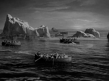 Movie still from “Titanic” (1953), directed by Jean Negulesco – A black and white photo of a group of people in a boat; Extreme Wide shot, High angle