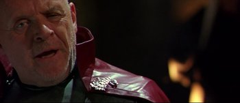 Movie still from “Titus” (1999), directed by Julie Taymor – A person wearing a red tie; Close Up shot, Over the shoulder angle
