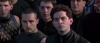 Movie still from “Titus” (1999), directed by Julie Taymor – A group of men standing next to each other; Close Up shot, Low angle