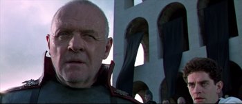 Movie still from “Titus” (1999), directed by Julie Taymor – A man's face in front of an archway; Close Up shot, Low angle
