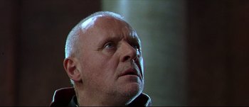 Movie still from “Titus” (1999), directed by Julie Taymor – An older man with a goatee looking upward; Close Up shot, Low angle