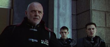 Movie still from “Titus” (1999), directed by Julie Taymor – A man and a boy in military uniforms standing next to each other; Close Up shot, Low angle
