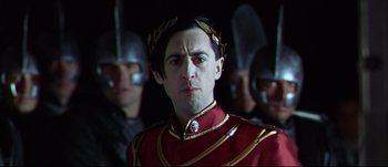 Movie still from “Titus” (1999), directed by Julie Taymor – A person wearing a uniform; Close Up shot, Over the shoulder angle