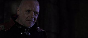 Movie still from “Titus” (1999), directed by Julie Taymor – A person wearing a jacket; Close Up shot, Low angle