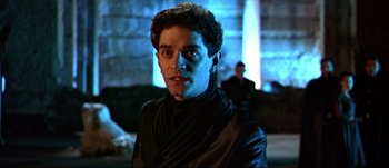 Movie still from “Titus” (1999), directed by Julie Taymor – A person wearing a black jacket; Close Up shot, Low angle