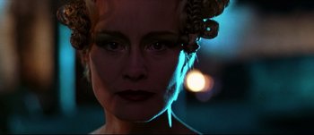 Movie still from “Titus” (1999), directed by Julie Taymor – A person wearing makeup and a headpiece; Close Up shot, Low angle