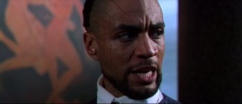 Movie still from “Titus” (1999), directed by Julie Taymor – A man's face with black paint on his face; Close Up shot, Low angle