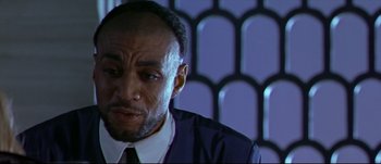 Movie still from “Titus” (1999), directed by Julie Taymor – A person wearing a suit and tie; Close Up shot, Low angle