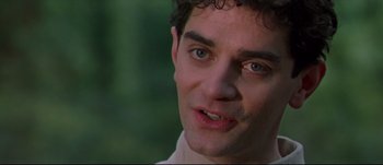 Movie still from “Titus” (1999), directed by Julie Taymor – A man's face with a green background; Close Up shot, Over the shoulder angle