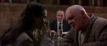 Movie still from “Titus” (1999), directed by Julie Taymor – Two men and a woman sitting at a dinner table; Close Up shot, Over the shoulder angle