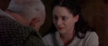 Movie still from “Titus” (1999), directed by Julie Taymor – A woman looking at an older man in a room; Close Up shot, Over the shoulder angle