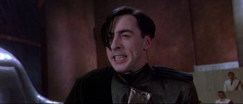 Movie still from “Titus” (1999), directed by Julie Taymor – A person wearing a suit and tie; Close Up shot, Low angle