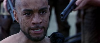 Movie still from “Titus” (1999), directed by Julie Taymor – A person holding a gun; Close Up shot, Over the shoulder angle