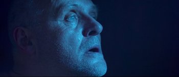 Movie still from “Titus” (1999), directed by Julie Taymor – A man's face in the dark; Close Up shot, Low angle