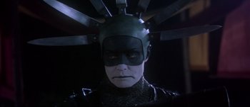 Movie still from “Titus” (1999), directed by Julie Taymor – A man with a helmet on his head; Close Up shot, Low angle