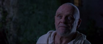 Movie still from “Titus” (1999), directed by Julie Taymor – An older man with a beard and a towel around his neck; Close Up shot, Low angle
