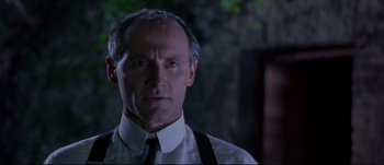 Movie still from “Titus” (1999), directed by Julie Taymor – A person wearing a shirt and a tie; Close Up shot, Low angle