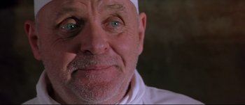 Movie still from “Titus” (1999), directed by Julie Taymor – An older man with a beard and a white hat; Close Up shot, Low angle