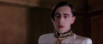 Movie still from “Titus” (1999), directed by Julie Taymor – A person wearing a white shirt; Close Up shot, Low angle