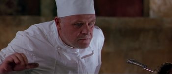 Movie still from “Titus” (1999), directed by Julie Taymor – A person wearing a chef's hat; Close Up shot, Low angle