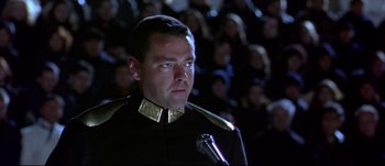 Movie still from “Titus” (1999), directed by Julie Taymor – A man in a military uniform is smoking a pipe; Close Up shot, Low angle
