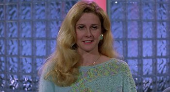 Movie still from “To Die For” (1995), directed by Gus Van Sant – A woman with long blonde hair wearing a light blue sweater; Close Up shot, Low angle