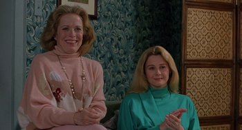 Movie still from “To Die For” (1995), directed by Gus Van Sant – Two women sitting next to each other on a couch; Medium shot, Over the shoulder angle