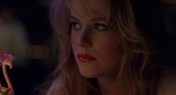 Movie still from “To Die For” (1995), directed by Gus Van Sant – A person with long blonde hair; Close Up shot, Over the shoulder angle
