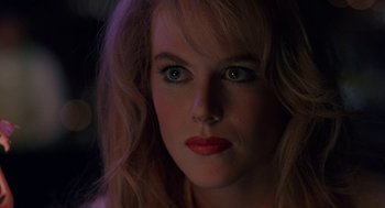Movie still from “To Die For” (1995), directed by Gus Van Sant – A person with long blonde hair; Close Up shot, Over the shoulder angle