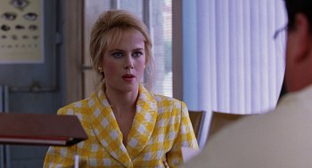 Movie still from “To Die For” (1995), directed by Gus Van Sant – A woman in a yellow and white checkered jacket; Close Up shot, Over the shoulder angle