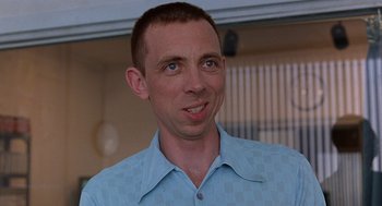 Movie still from “To Die For” (1995), directed by Gus Van Sant – A person wearing a blue shirt; Close Up shot, Over the shoulder angle